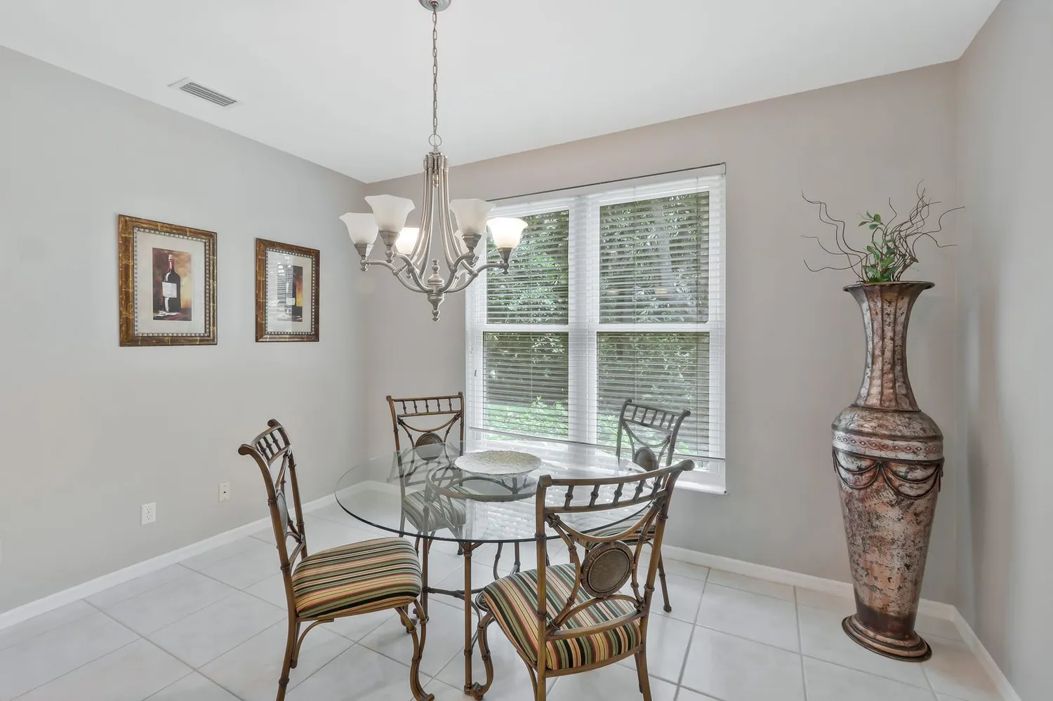a view of a dining room and livingroom with furniture wooden floor a chandelier
