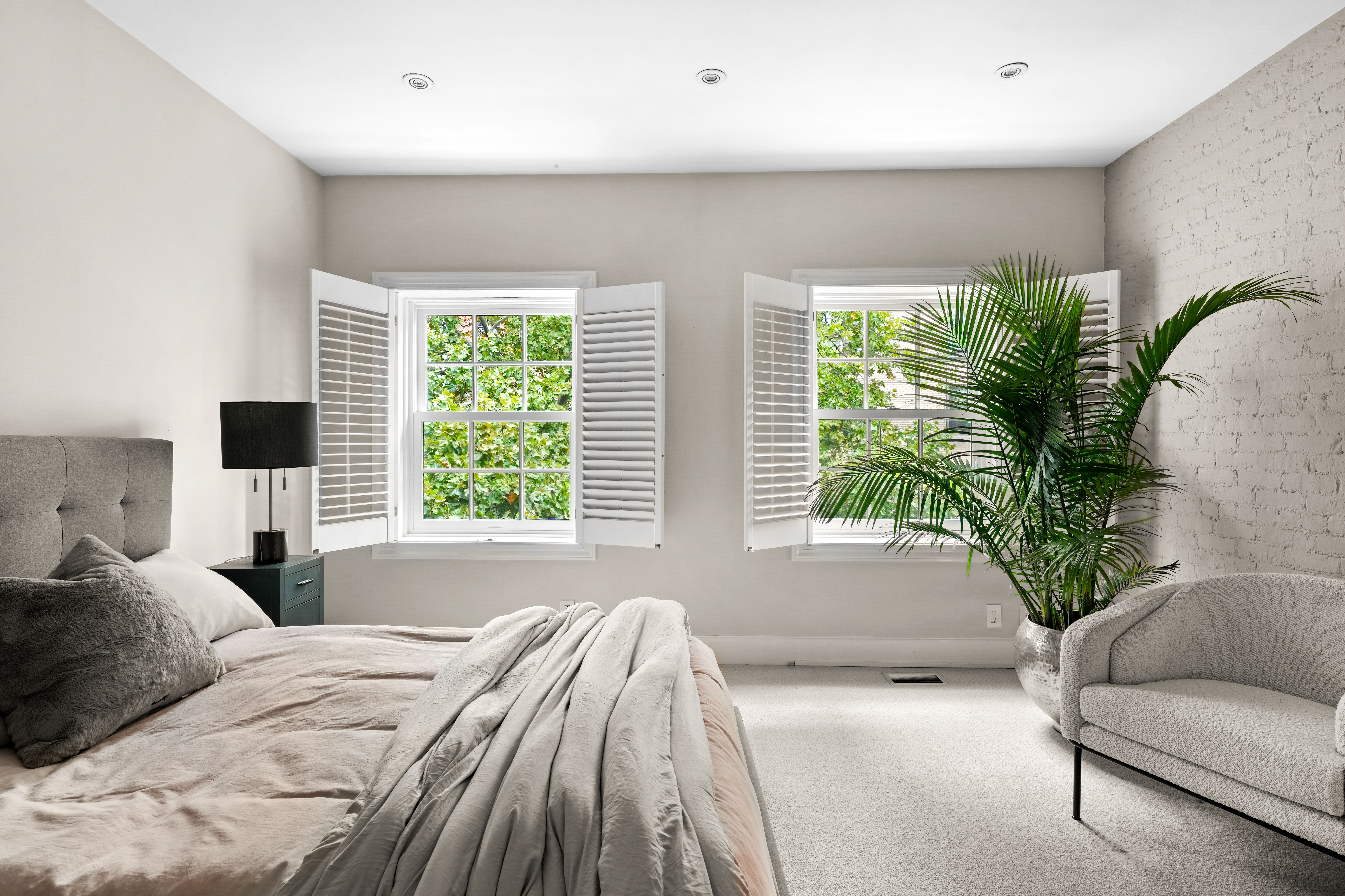 247 East 71st Street Manhattan, NY 10021 - Photo 23 of 31 a bedroom with a bed and a potted plant