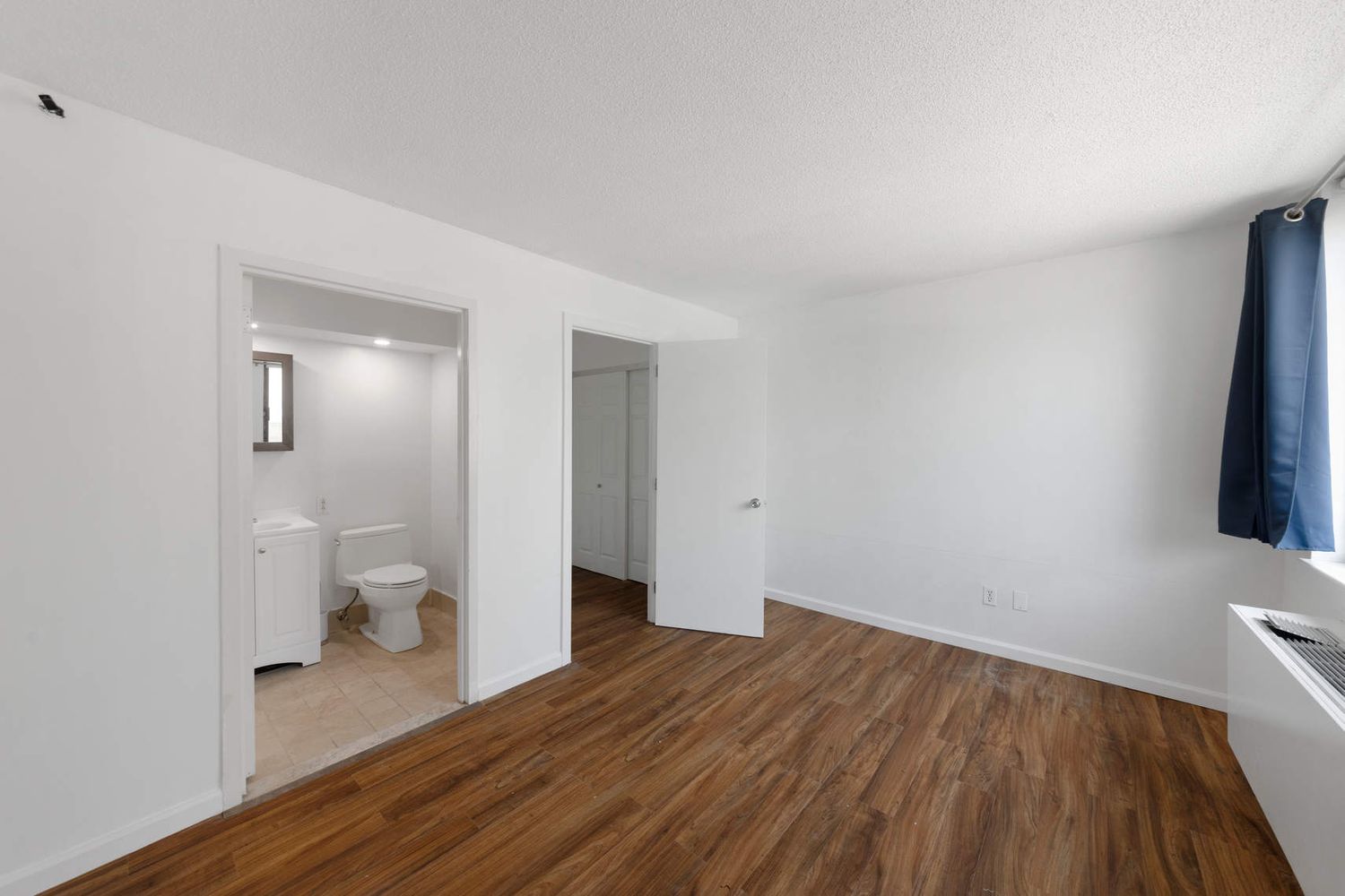376 Broadway, Unit 8F Manhattan, NY 10013 - Photo 12 of 20 a view of a room with wooden floor and a toilet