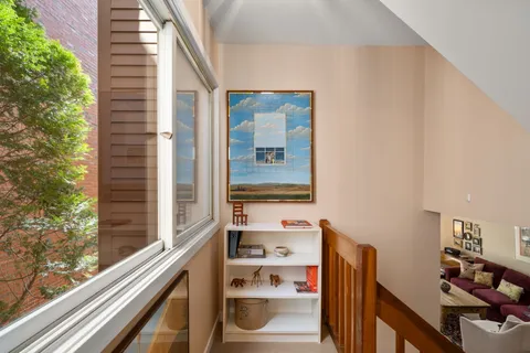 a view of a balcony with wooden floor and fence