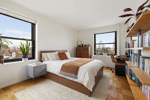 a bed room with a bed and a large window