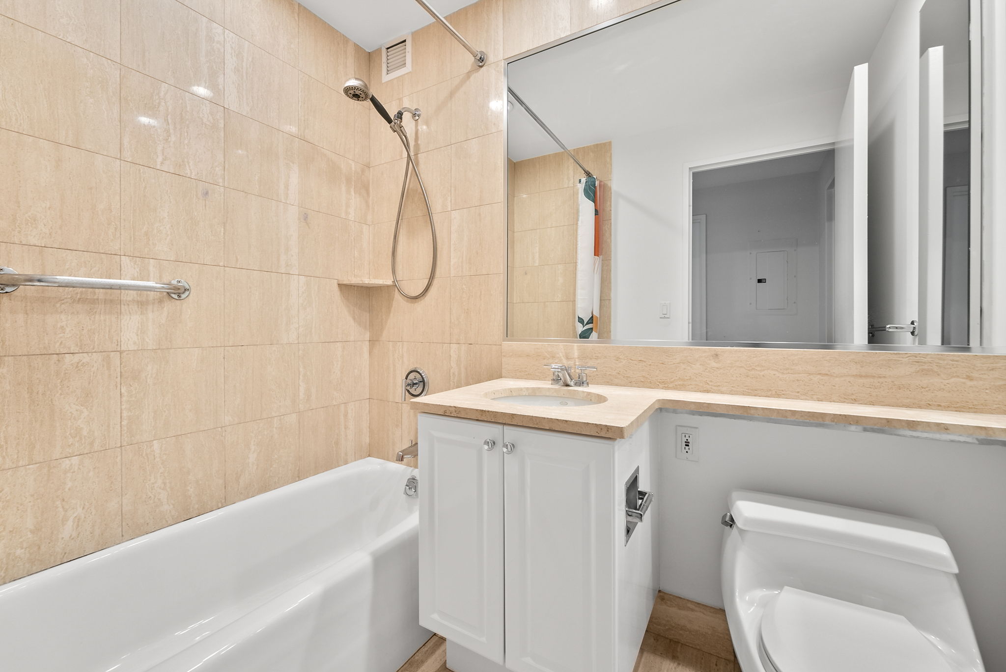 220 Riverside Boulevard, Unit 4M Manhattan, NY 10069 - Photo 9 of 11 a bathroom with a granite countertop sink a toilet and shower