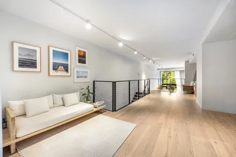 a view of a livingroom with furniture and hardwood floor
