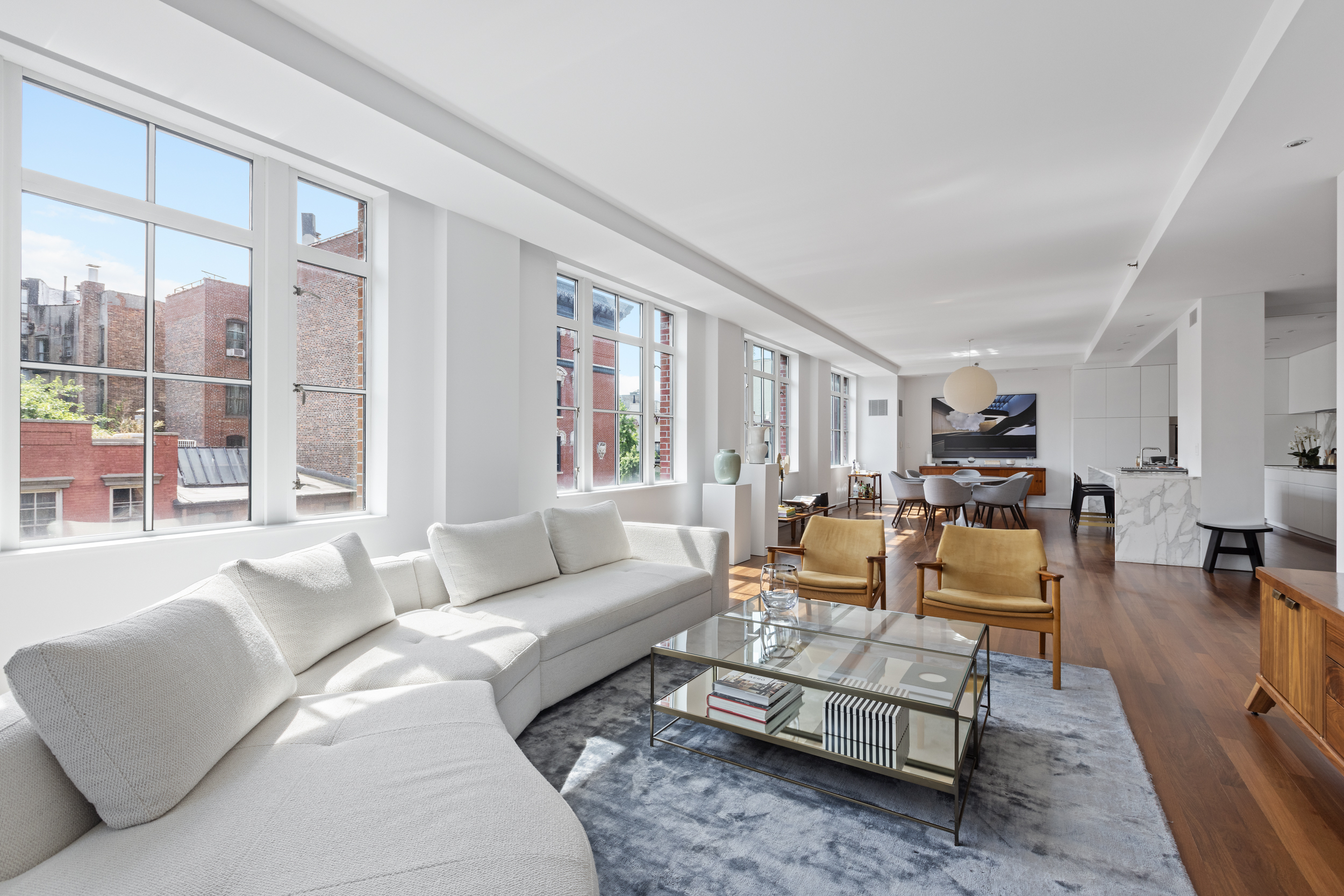 744 Greenwich Street, Unit 4 Manhattan, NY 10014 - Photo 2 of 34 a living room with furniture wooden floor and a large window
