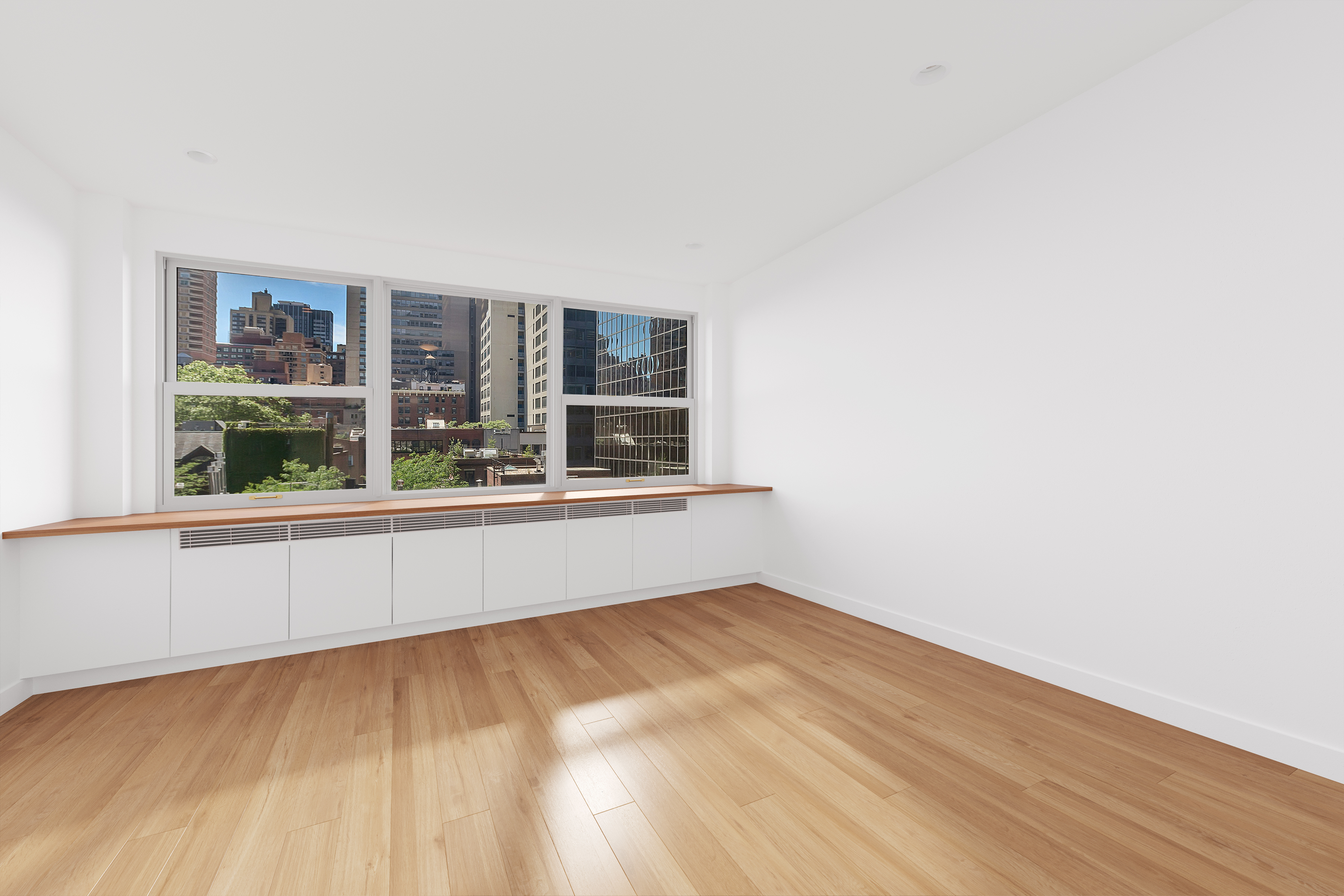 221 East 50th Street, Unit 6D/7D Manhattan, NY 10022 - Photo 11 of 19 a view of an empty room with a window and wooden floor