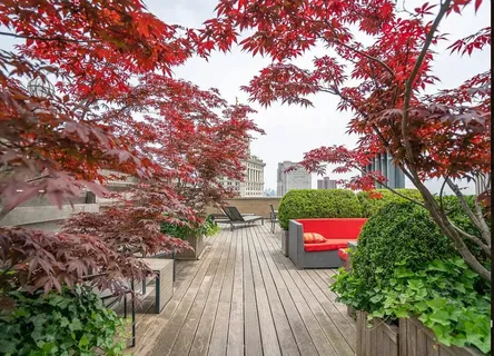 a roof deck with a table and chairs
