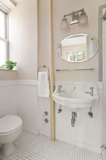a bathroom with a sink a toilet and a mirror