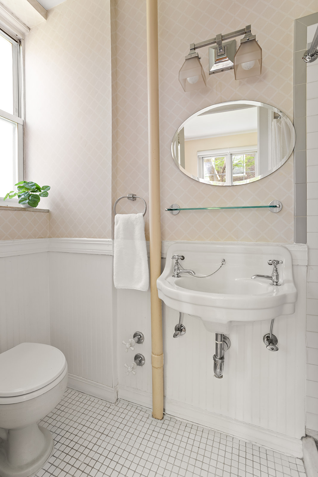 34-28 80th Street, Unit 2 Queens, NY 11372 - Photo 6 of 12 a bathroom with a sink a toilet and a mirror