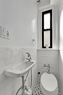 a bathroom with a sink a toilet and mirror