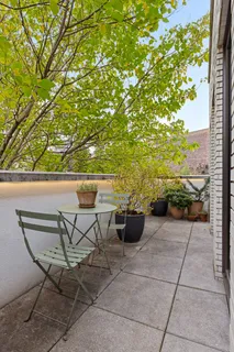 a view of patio with couple of chairs