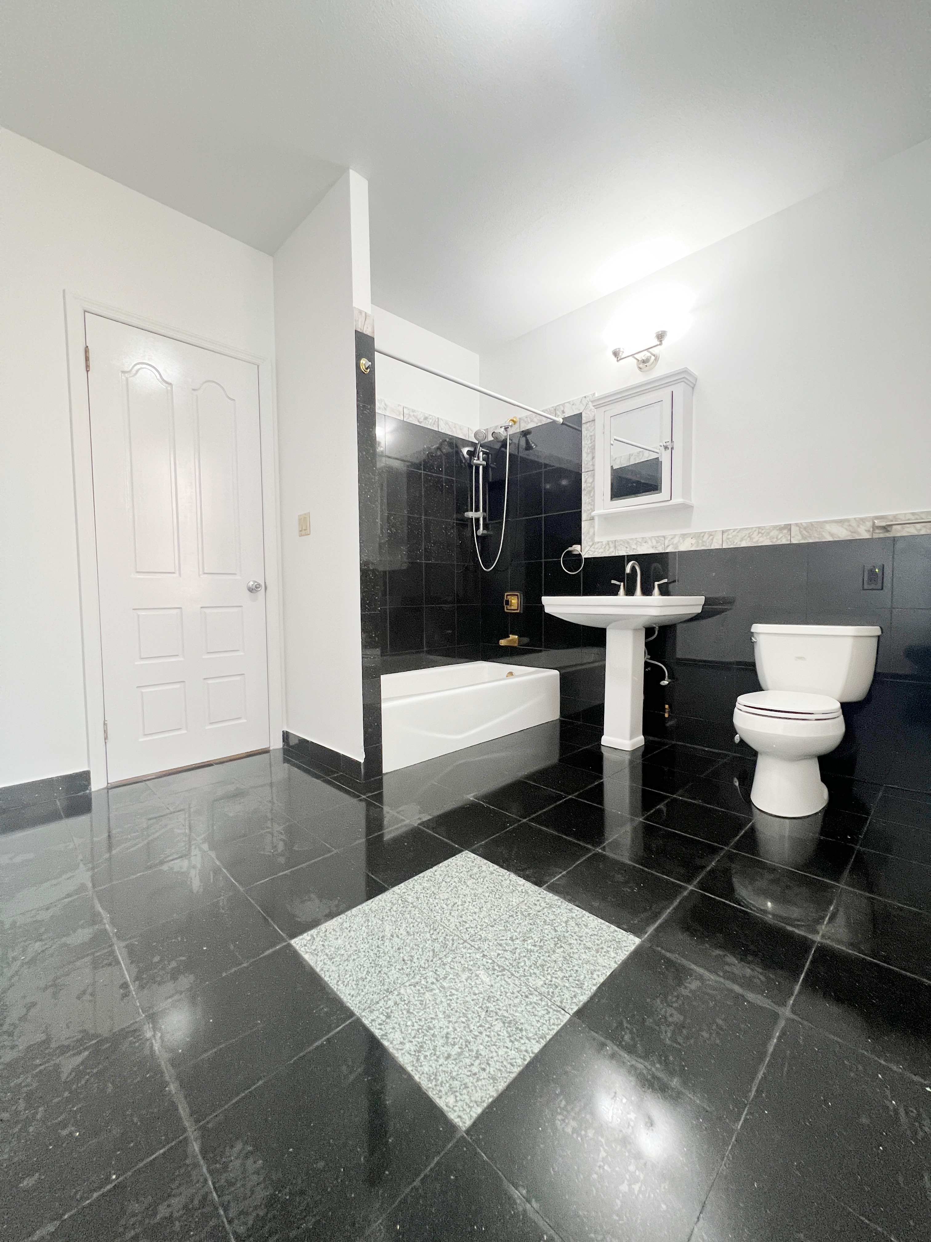 75 Madison Street, Unit 6 Manhattan, NY 10002 - Photo 5 of 5 a bathroom with a sink toilet and shower