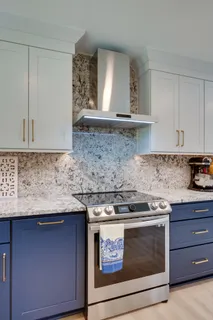 a kitchen with stainless steel appliances granite countertop wooden cabinets a sink and a window