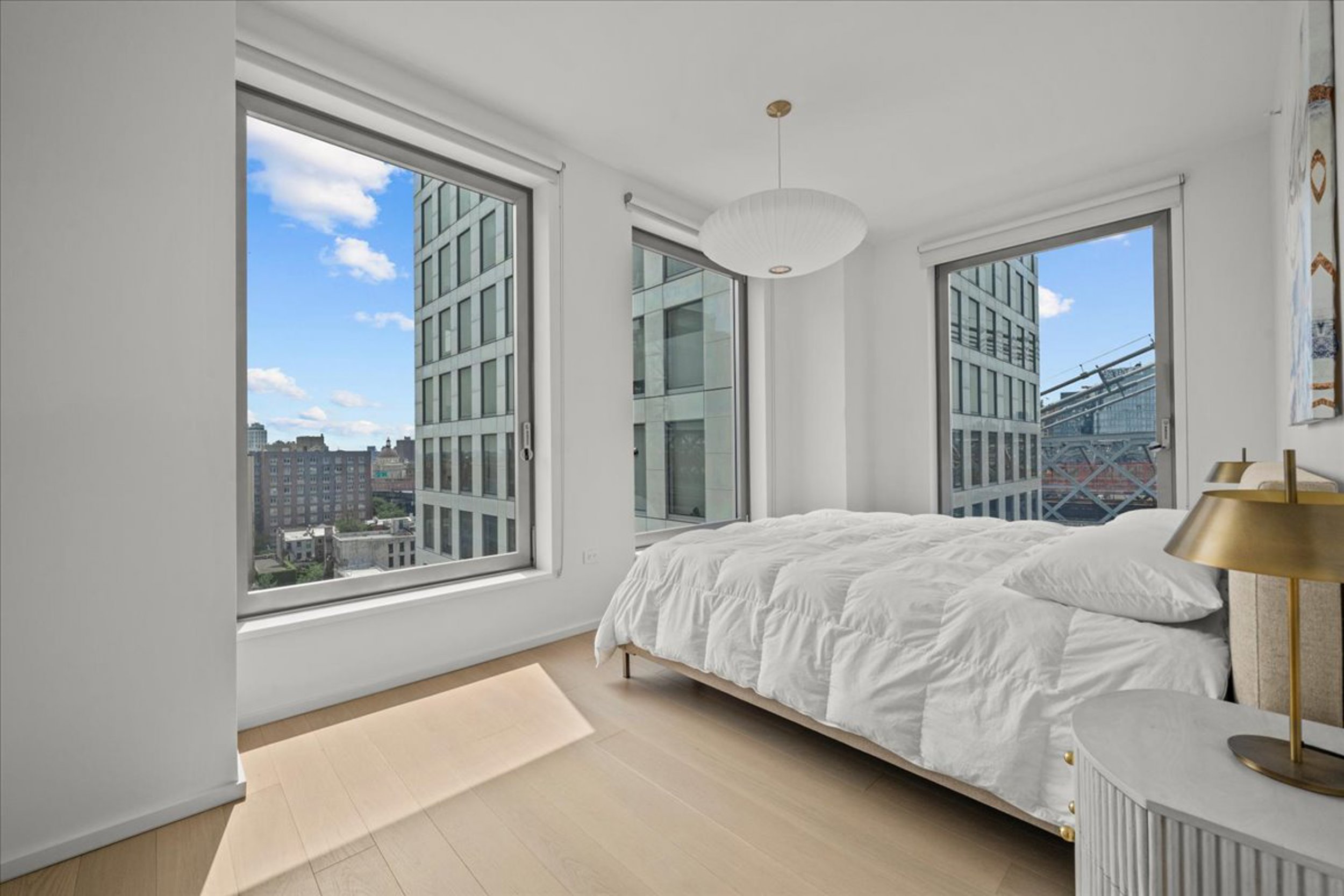 8 South 4th Street, Unit 15D Brooklyn, NY 11249 - Photo 6 of 29 a bedroom with a bed lamp and window