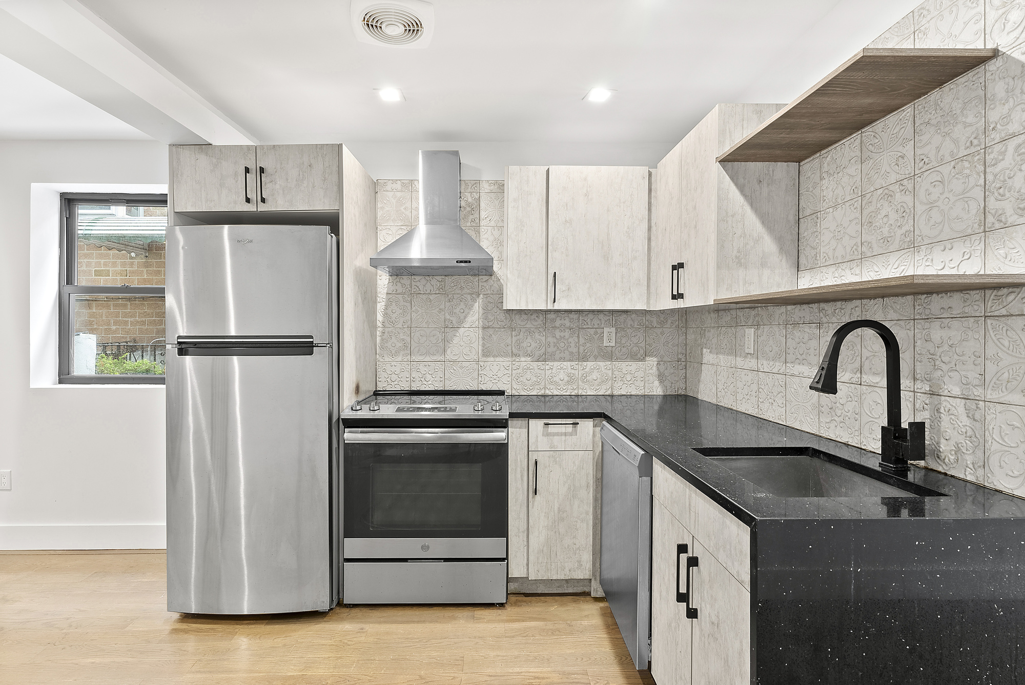 81 Eldert Street, Unit 1 Brooklyn, NY 11207 - Photo 4 of 9 a kitchen with stainless steel appliances granite countertop a sink a stove and refrigerator