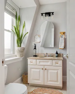 a bathroom with a toilet a sink a window and mirror