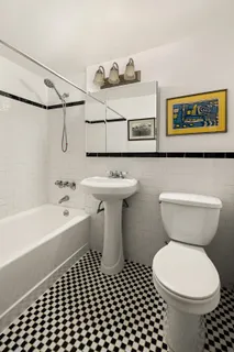 a bathroom with a toilet a sink and bathtub