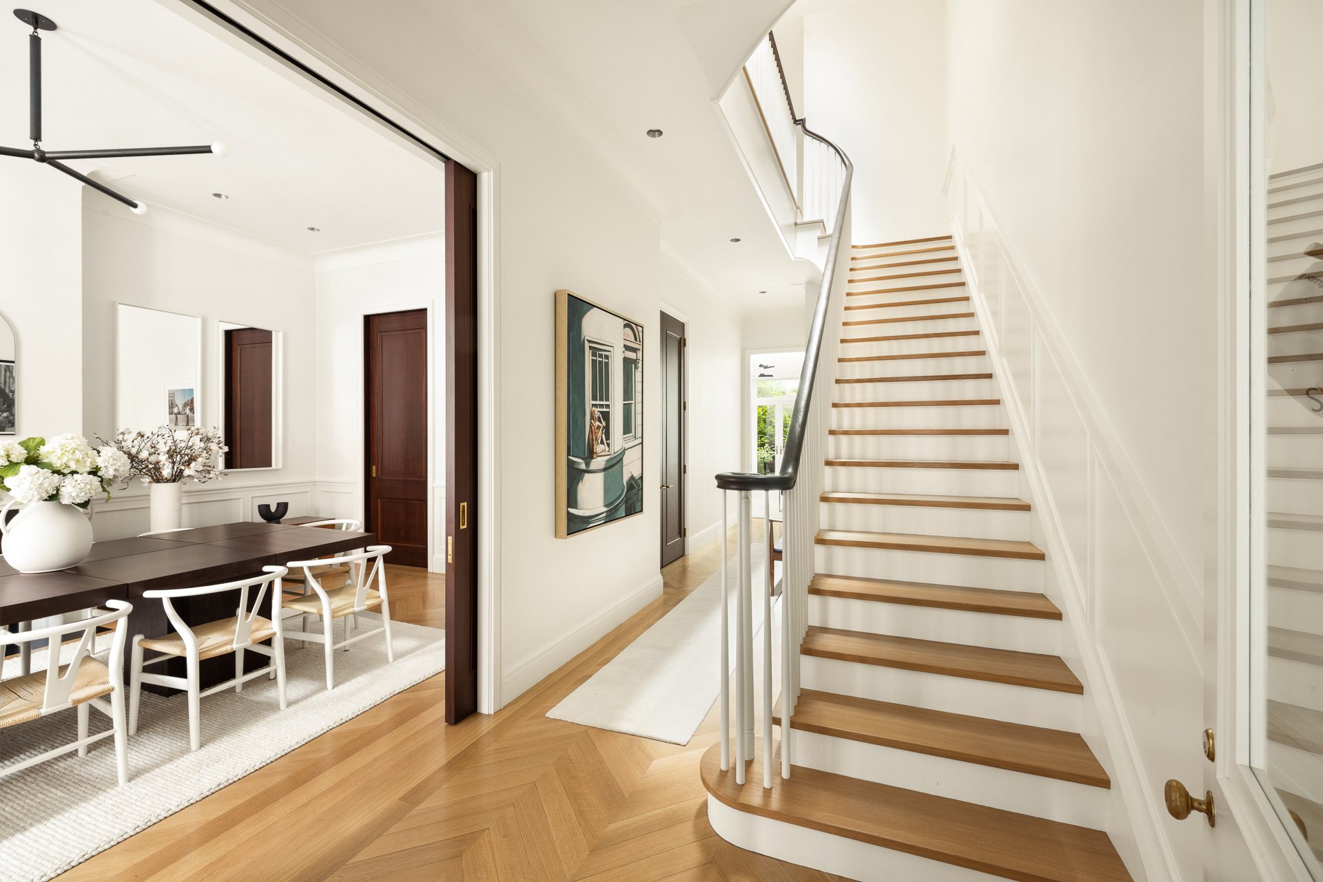 334 West 20th Street Manhattan, NY 10011 - Photo 4 of 20 a view of a hallway with dining room and wooden floor