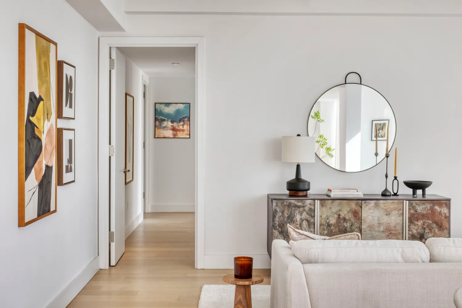 a living room with furniture and a mirror