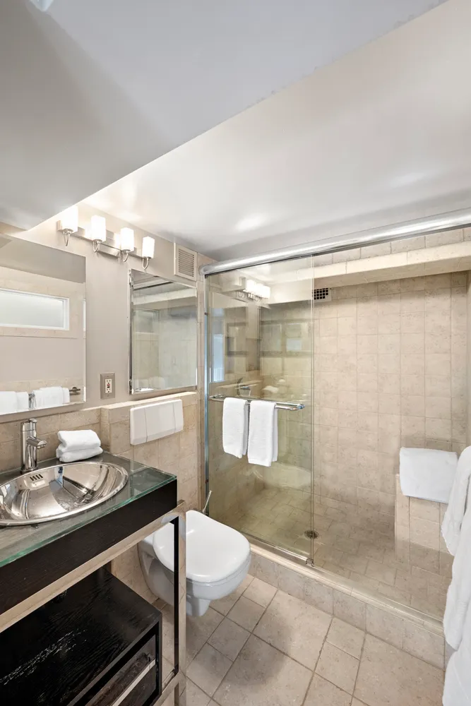 a bathroom with a sink toilet and shower