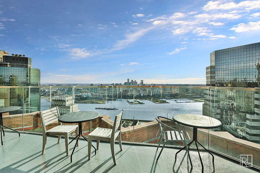 75 Wall Street, Unit 28D Manhattan, NY 10005 - Photo 30 of 35 a view of a chairs and table on the terrace