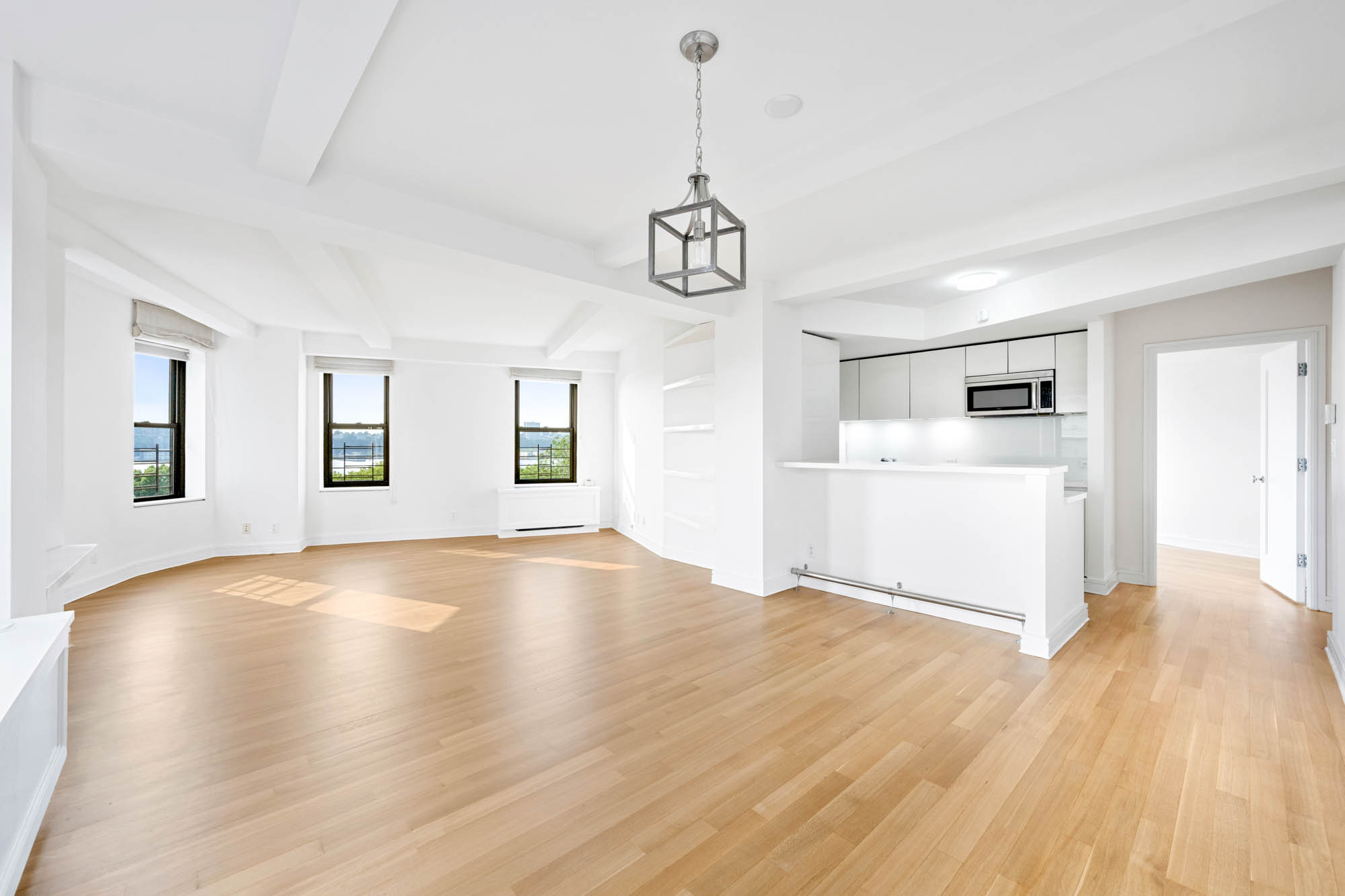 230 Riverside Drive, Unit 8D Manhattan, NY 10025 - Photo 2 of 19 a view of a livingroom with wooden floor and a ceiling fan
