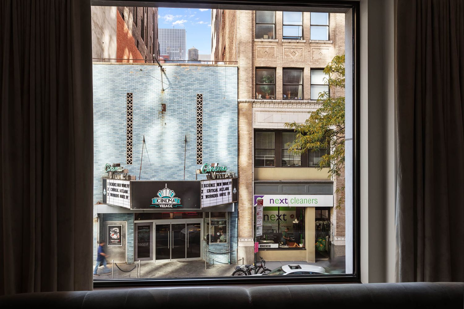 a living room with a large window and a fireplace