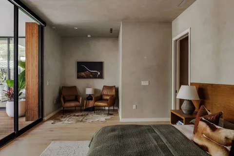 a bedroom with a bed and glass window