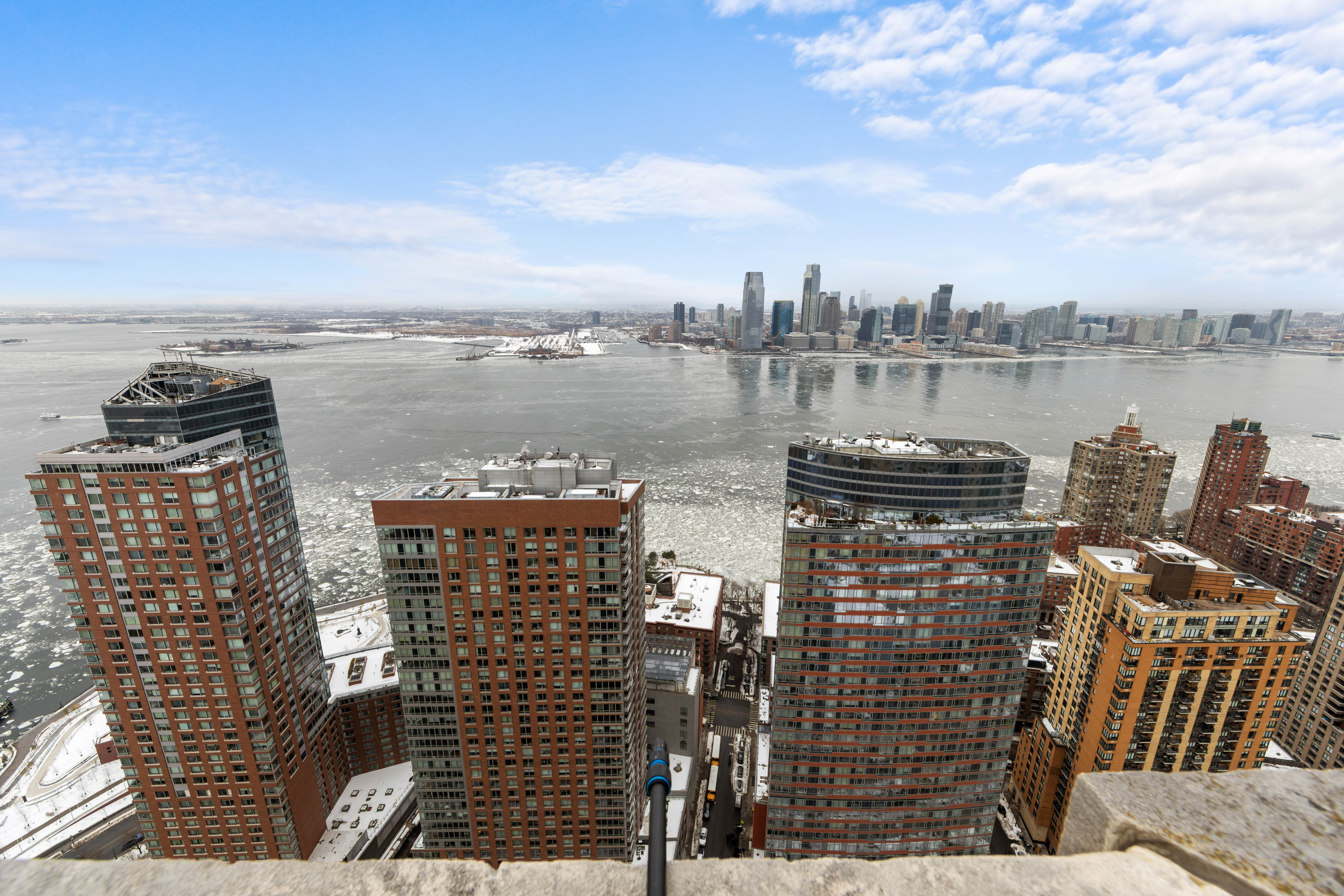 20 West Street, Unit 41D Manhattan, NY 10004 - Photo 13 of 17 a view of a lake with a building in front of it