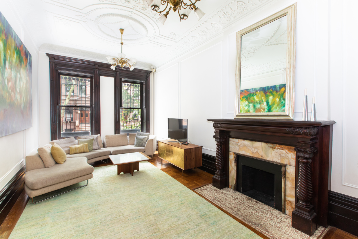 27 West 87th Street, Unit 1 Manhattan, NY 10024 - Photo 4 of 12 a living room with furniture and a fireplace