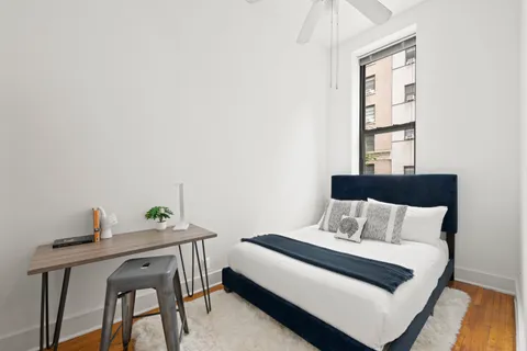 a bedroom with a bed and a window