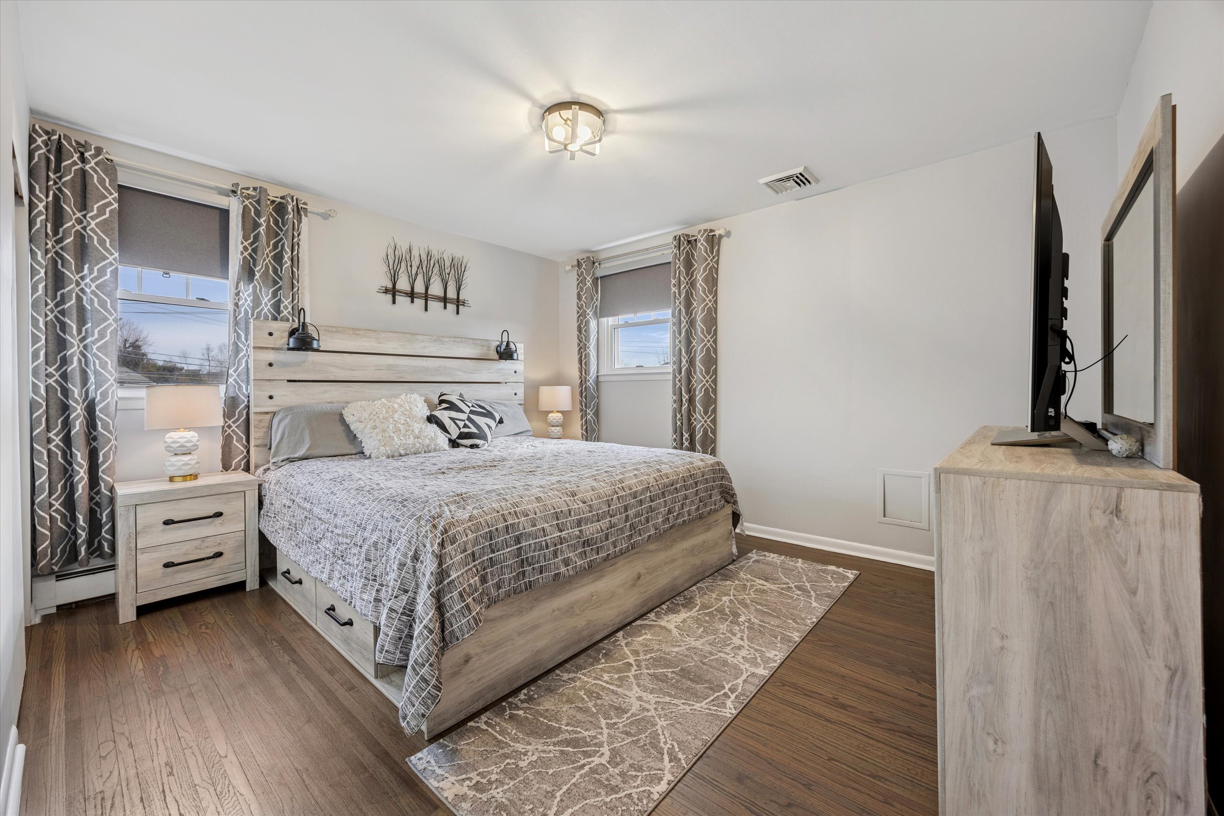 535 Bell Lane Ambler, PA 19002 - Photo 16 of 45 a bedroom with a bed and a flat tv screen on dresser