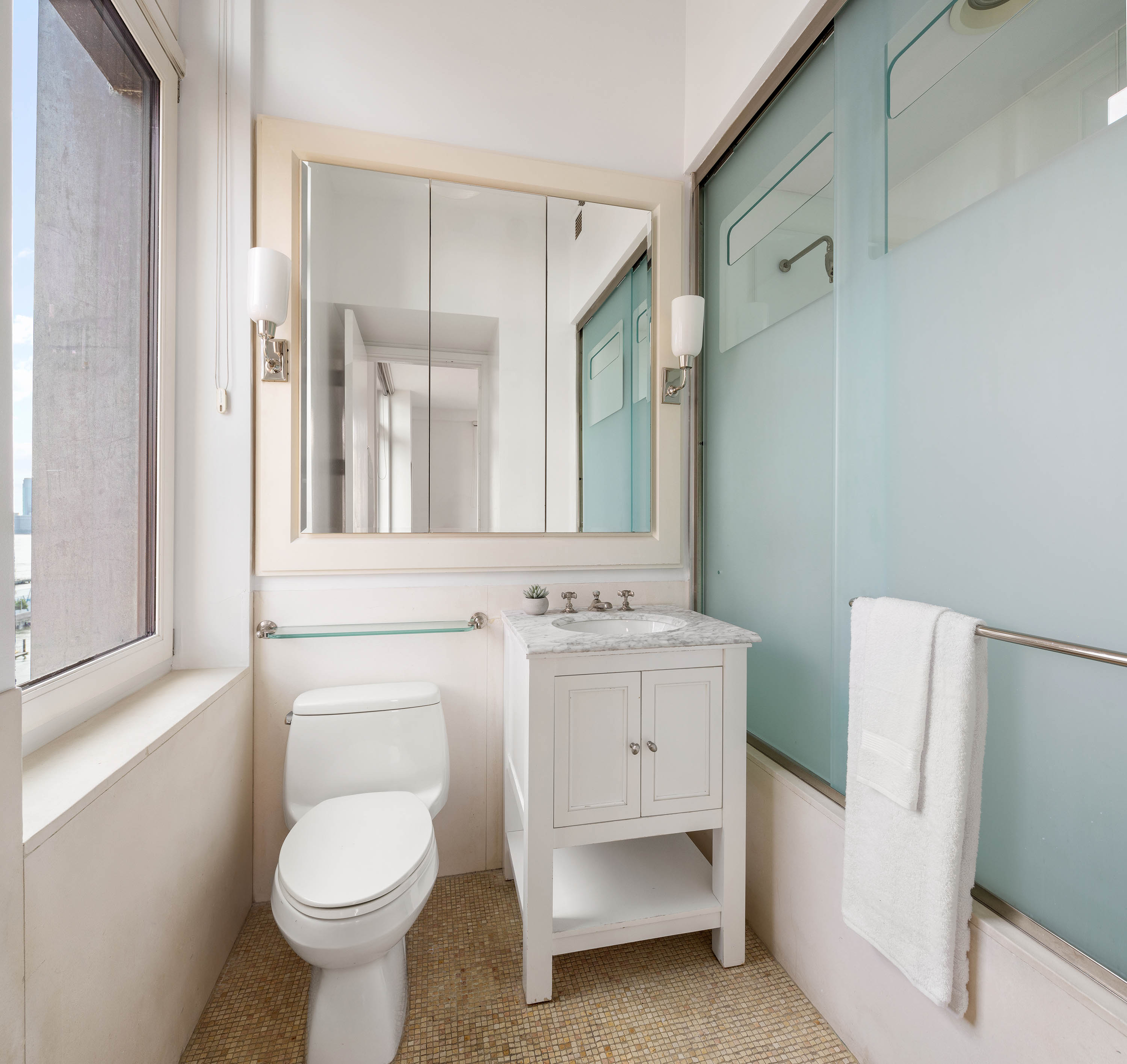 92 Laight Street, Unit 11A Manhattan, NY 10013 - Photo 10 of 15 a bathroom with a toilet sink and mirror