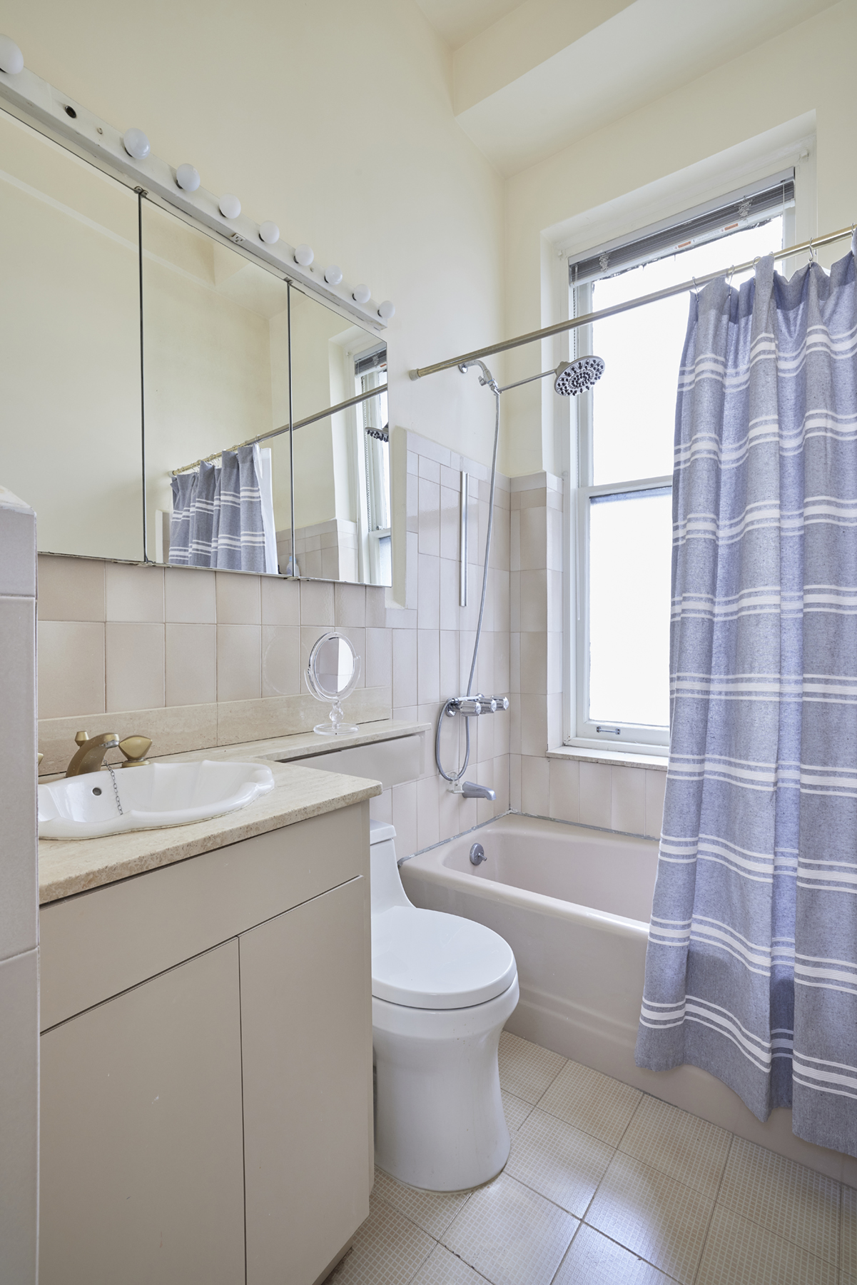 907 5th Avenue, Unit 4F Manhattan, NY 10021 - Photo 8 of 13 a bathroom with a sink and a mirror