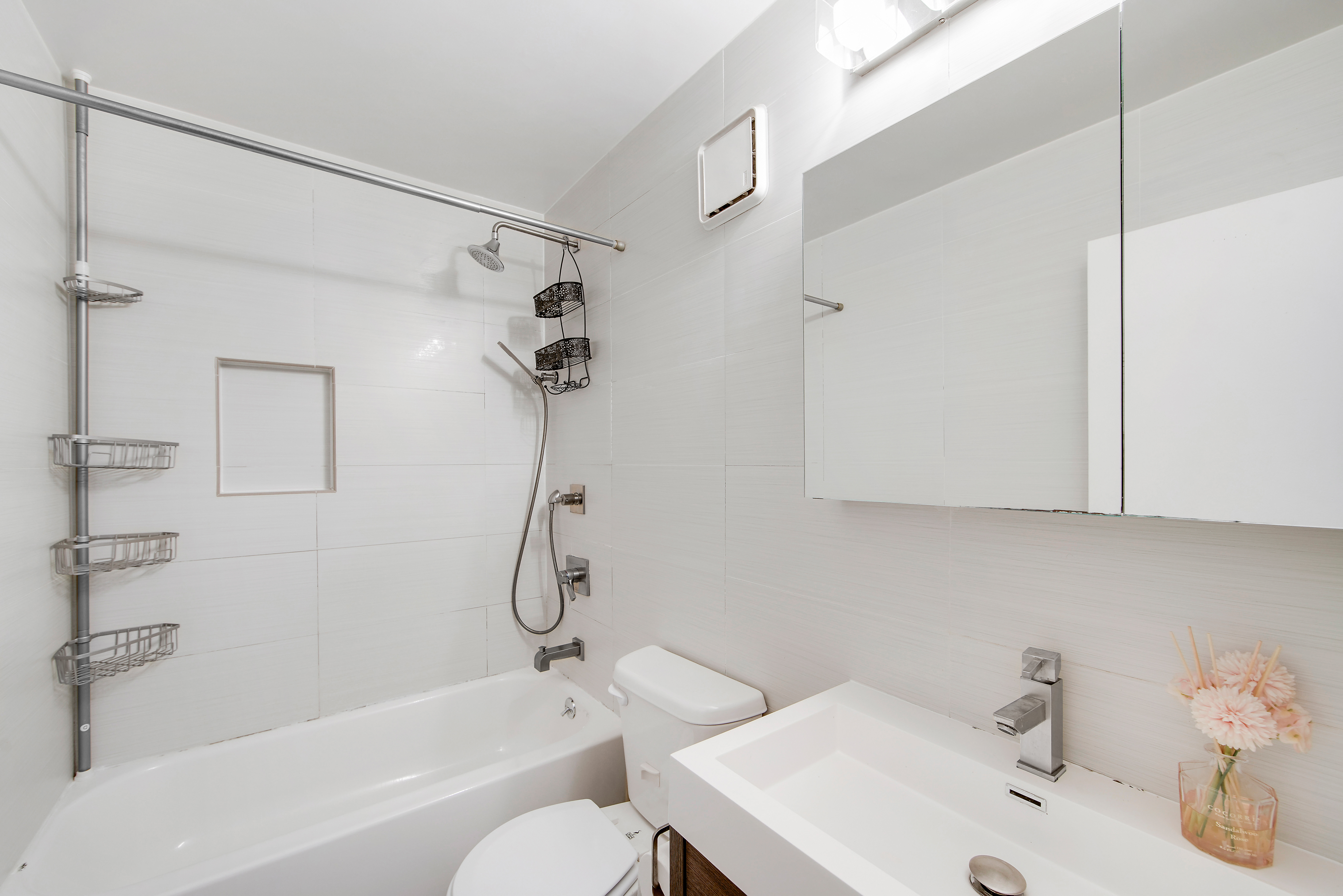 25-40 Shore Boulevard, Unit 15S Queens, NY 11102 - Photo 12 of 21 a bathroom with a sink toilet and shower