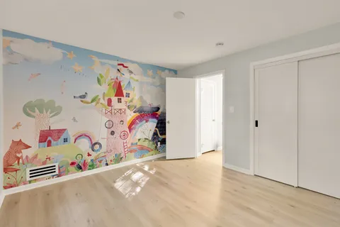 a view of an empty room and wooden floor