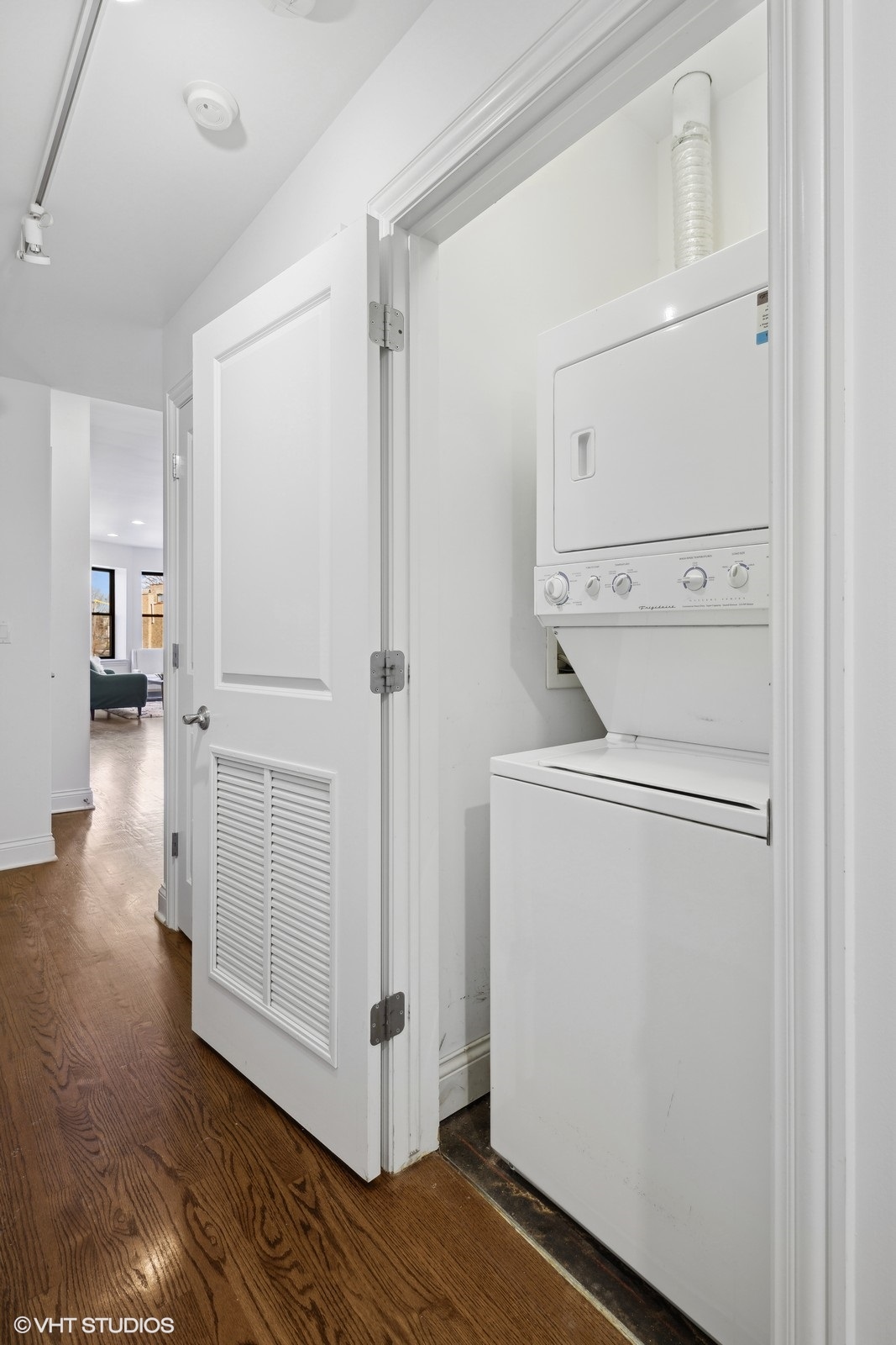 1227 East 46th Street, Unit 2E Chicago, IL 60653 - Photo 14 of 16 a view of washer and dryer with wooden floor