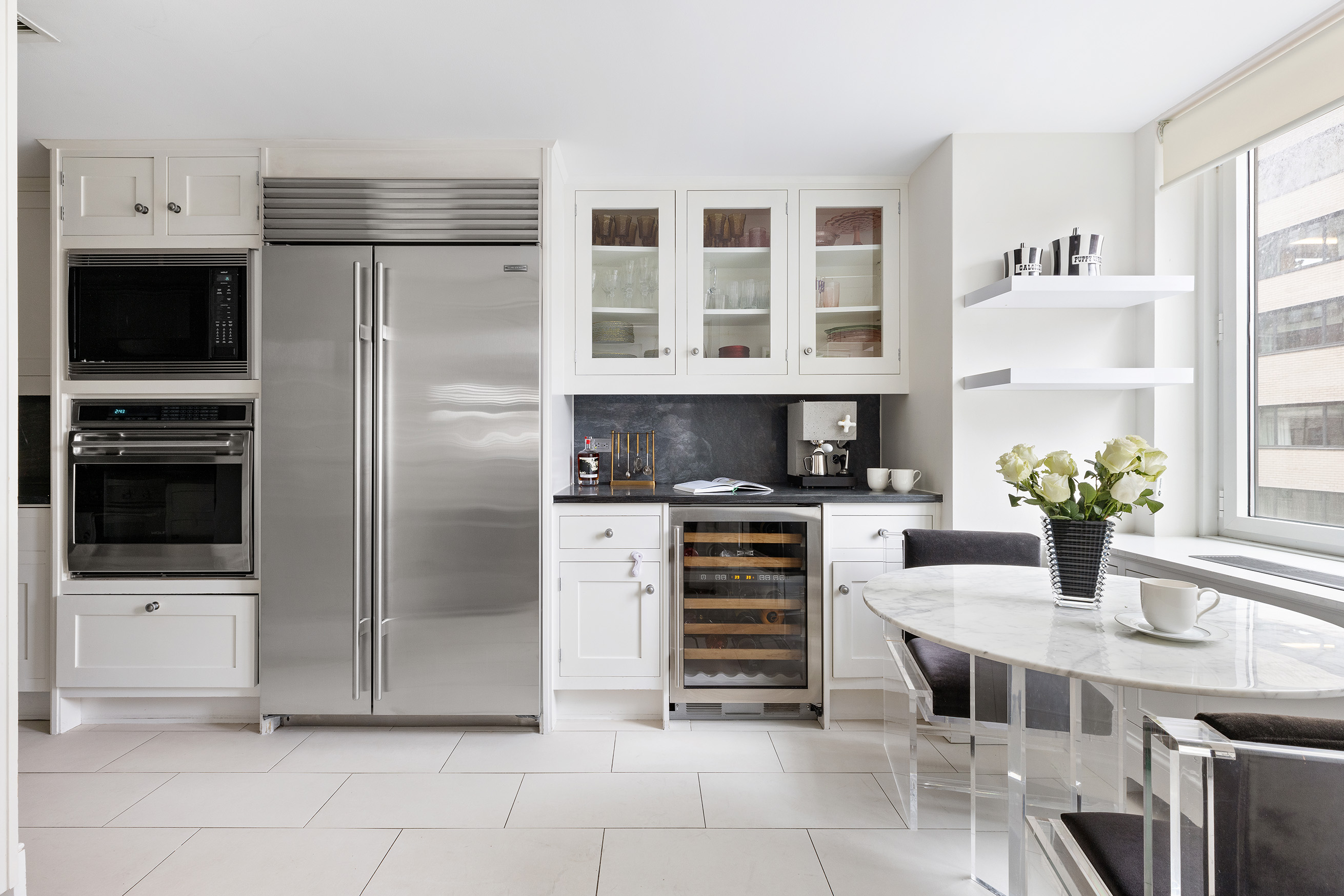 530 Park Avenue, Unit 14D Manhattan, NY 10065 - Photo 6 of 12 a kitchen with stainless steel appliances a refrigerator and a stove
