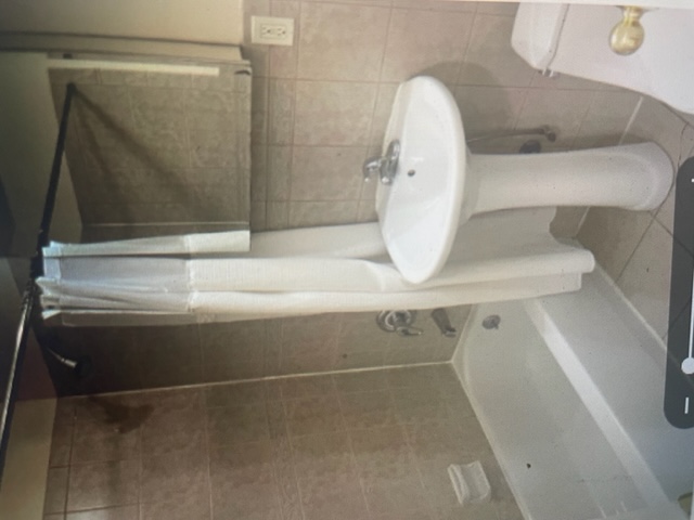 250 57th Street Brooklyn, NY 11220 - Photo 11 of 15 a bathroom with a sink a toilet and shower