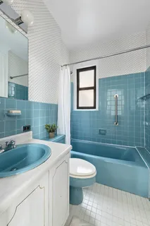 a bathroom with a sink a toilet a mirror and bathtub