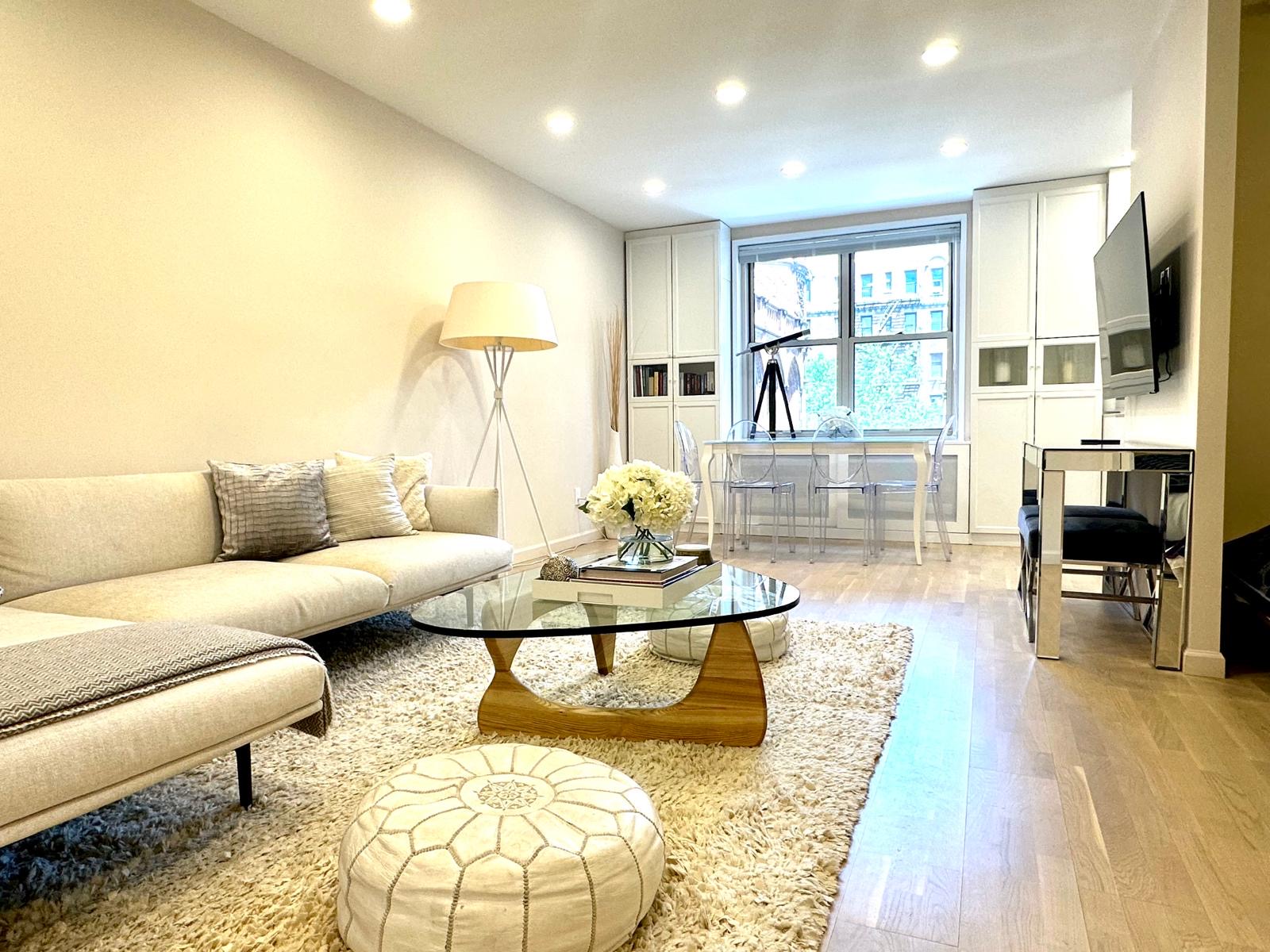 309 East 87th Street, Unit 3L Manhattan, NY 10128 - Photo 11 of 14 a living room with furniture and a wooden floor