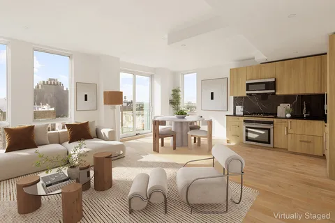 a living room with furniture a large window and a fireplace