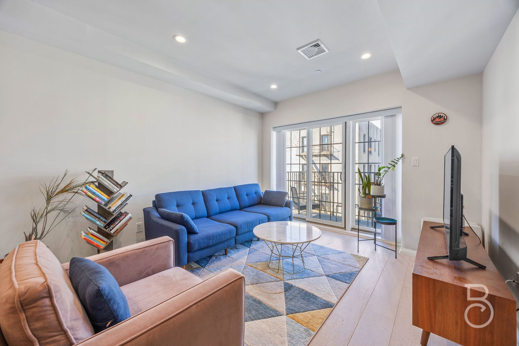 25-74 34th Street, Unit 4C Queens, NY 11103 - Photo 3 of 15 a living room with furniture and a flat screen tv