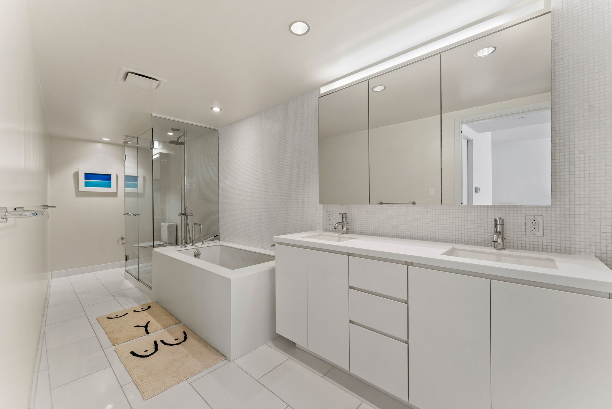 425 West 53rd Street, Unit 416 Manhattan, NY 10019 - Photo 7 of 19 a spacious bathroom with a double sink mirror and bathtub