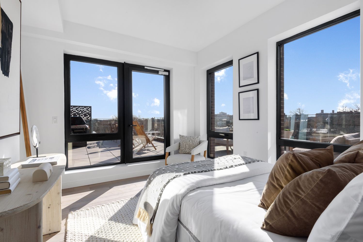 a bedroom with a bed and large windows