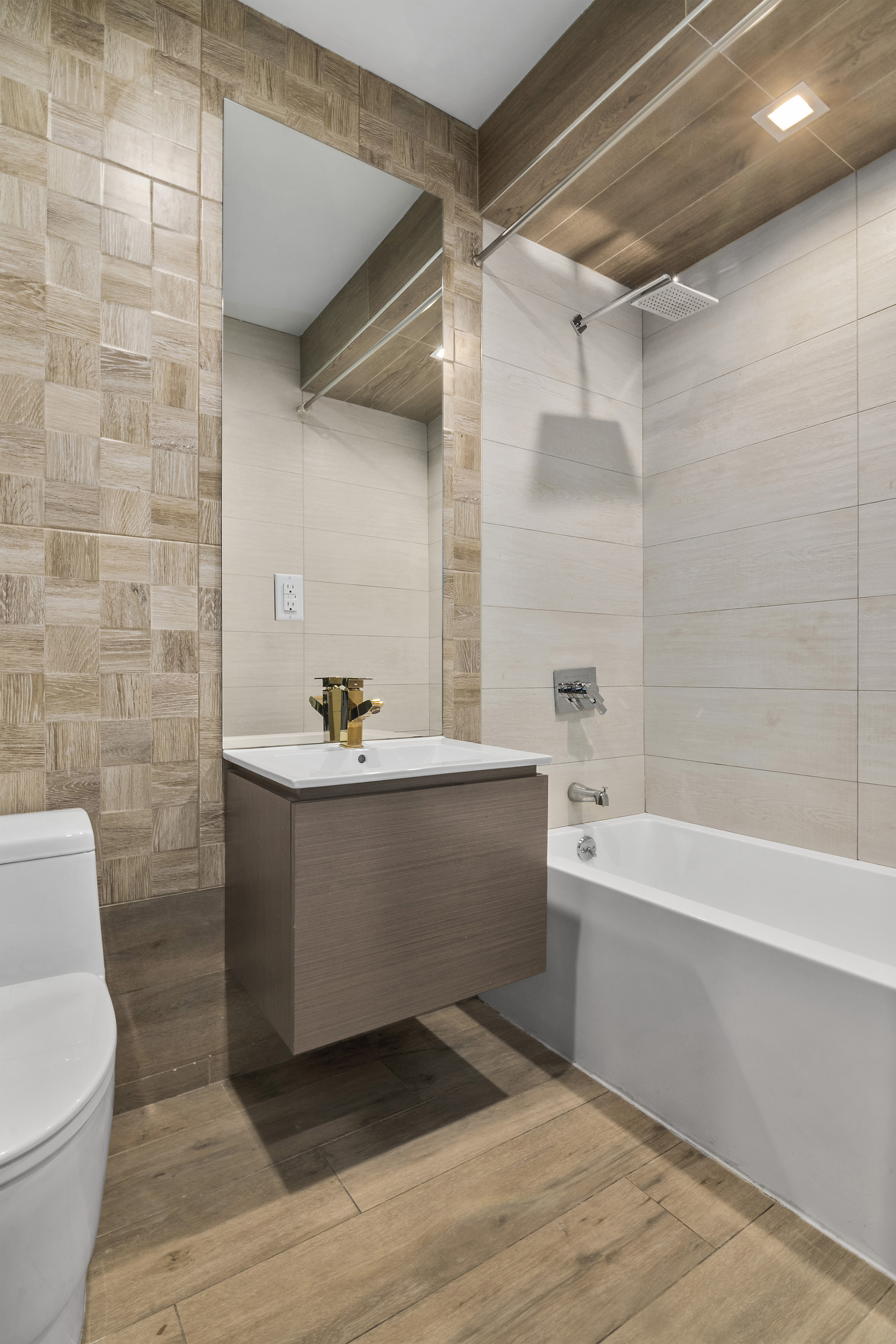 20-27 Menahan Street, Unit 1R Queens, NY 11385 - Photo 7 of 12 a bathroom with a bathtub a sink and a toilet