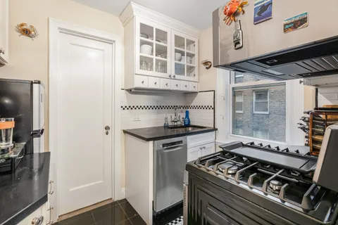 a stove top oven sitting inside of a kitchen
