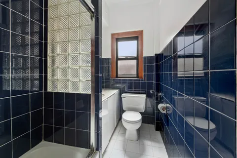 a bathroom with a toilet a sink and shower