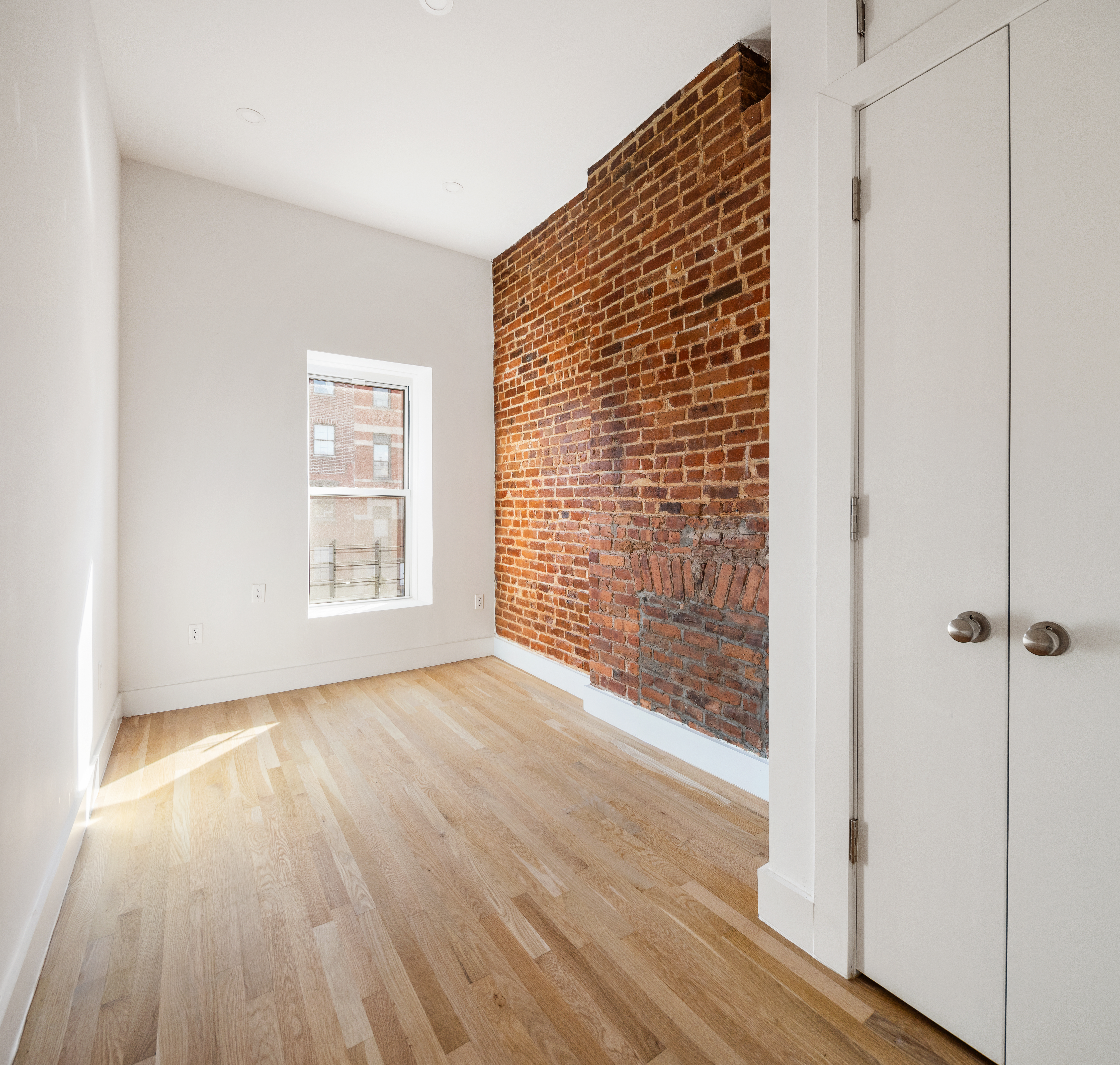 502 5th Avenue, Unit 3 Brooklyn, NY 11215 - Photo 7 of 10 a view of an empty room with wooden floor and a window