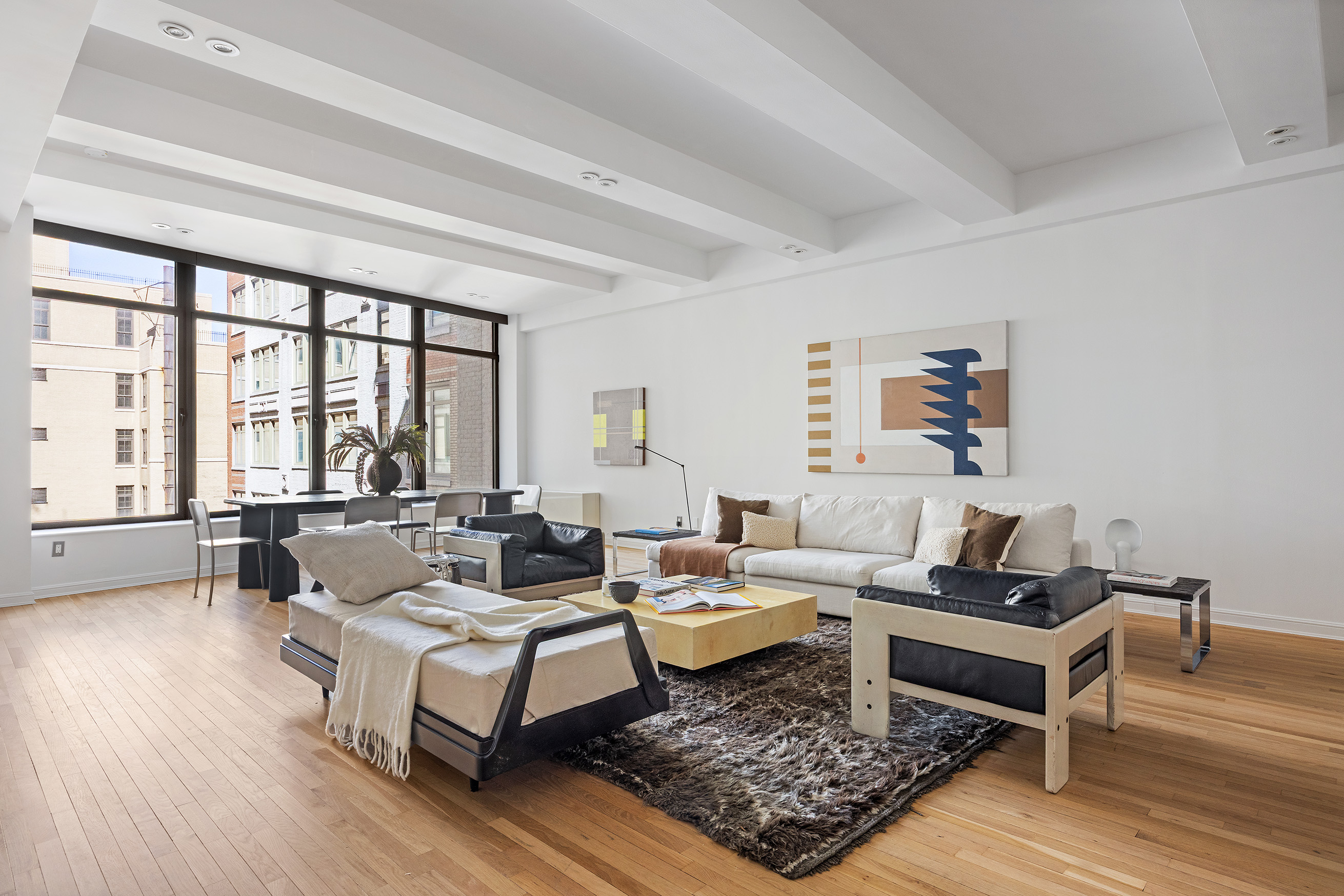 252 7th Avenue, Unit 9R Manhattan, NY 10001 - Photo 3 of 23 a living room with furniture and a rug