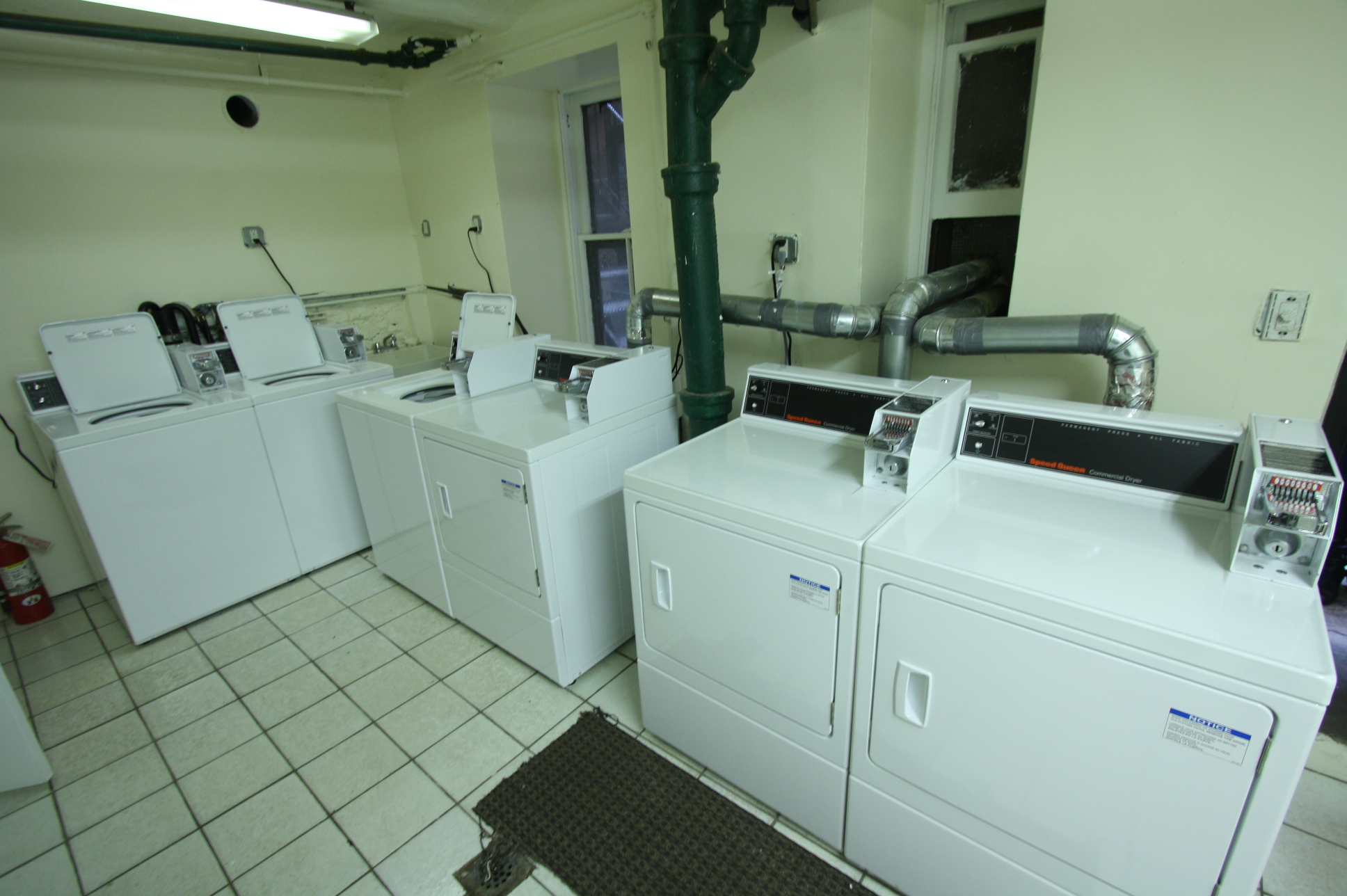 435 East 75th Street, Unit 13 Manhattan, NY 10021 - Photo 6 of 6 a utility room with dryer and washer